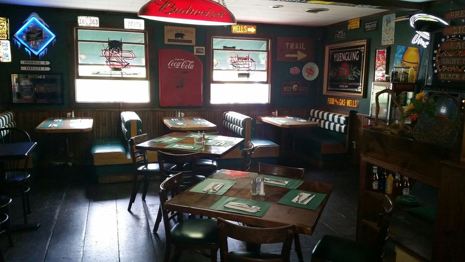 Sports screens above a relaxed dining room.